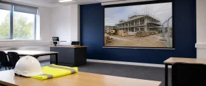 Empty construction safety training classroom with PPE on a desk